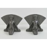 A good pair of cast metal Art Deco bookends each in the form of a kneeling nude female with splayed