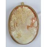 A large and well carved shell cameo brooch/pendant having 9ct gold frame,