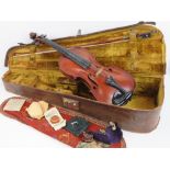 A vintage leather violin case opening to reveal felt lined compartment within,