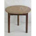 A 19th century mahogany cricket table raised over three legs, 45cm dia, old repairs.