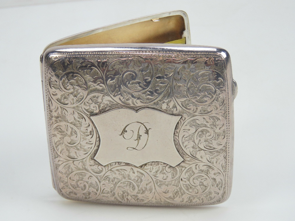 A HM silver cigarette case having gilt interior and elasticated straps, hallmarked Birmingham 1906,