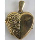 A 9ct gold heart shaped locket having scrolling vine engraving to front and back, 1.