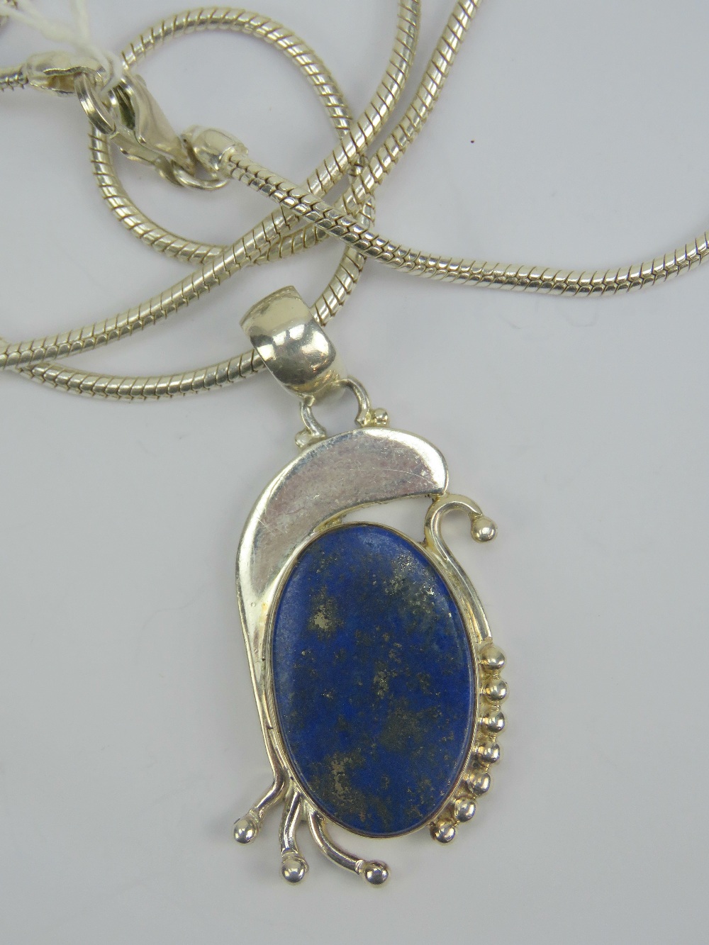 A silver and lapis lazuli pendant,