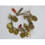A 9ct gold charm bracelet, hallmarked 375, and having nineteen charms upon including 'coins',