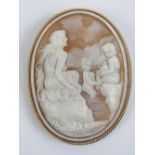 A large cameo brooch having well carved classical scene upon being a woman and two children bathing
