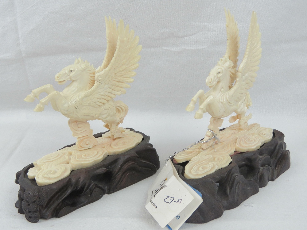 A pair of Pegusus like winged horses carved from Woolly Mammoth tusk segments (Extinct Genus