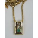 A 9ct gold diamond and emerald pendant, the square cut emerald and diamond in channel setting,