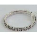 A 18ct white gold and diamond eternity ring, hallmarked 750, size N, 1.9g.