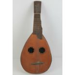 A 19th century inlaid walnut gourd type lute having double sound holes and thick shaped neck, a/f,