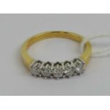 An 18ct gold five stone diamond ring, the round cut brilliant diamonds totalling 0.
