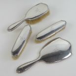 A superb HM silver four piece ladies dressing table set comprising bevel edged hand mirror with