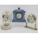 A Wedgwood Jasperware clock, together with a Hermle quartz clock in dome, and one other clock.