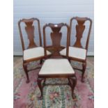 A set of three early 20th century mahogany Queen Anne style high back dining chairs each with drop