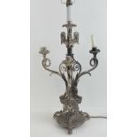 A heavy once silver plated candelabrum now wired for electricity in the central sconce and having