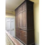 A very large and impressive early 19th century estate linen cupboard in oak comprising twin doors