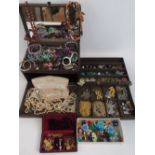 A quantity of vintage and modern costume jewellery within contemporary leatherette jewellery box.