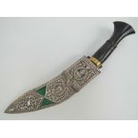 A fine quality Kukhri knife having curved decorated blade, brass and turned horn handle.