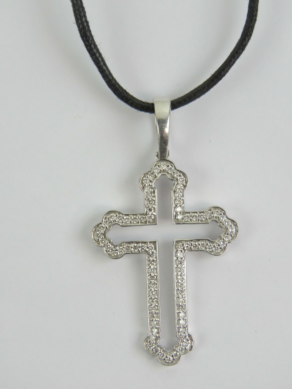 An 18ct white gold cross set with diamon