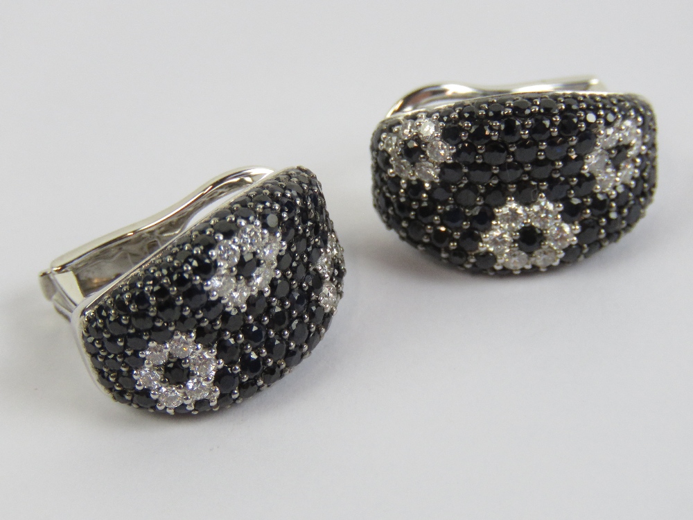 A pair of 18ct white gold earrings set w