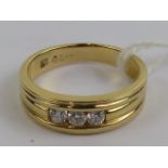 An 18ct gold and diamond ring, the three