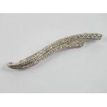 An 18ct white gold and diamond brooch in