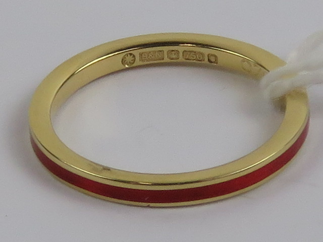 An 18ct gold ring having central red ena