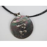 A silver and Abalone shell pendant on wi