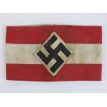 A WWII German swastika armband, SS issue having maker marks upon and labels with military stamps,