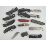 A quantity of fifteen Military issue and pocket knives including; Vitrinox, Buck,