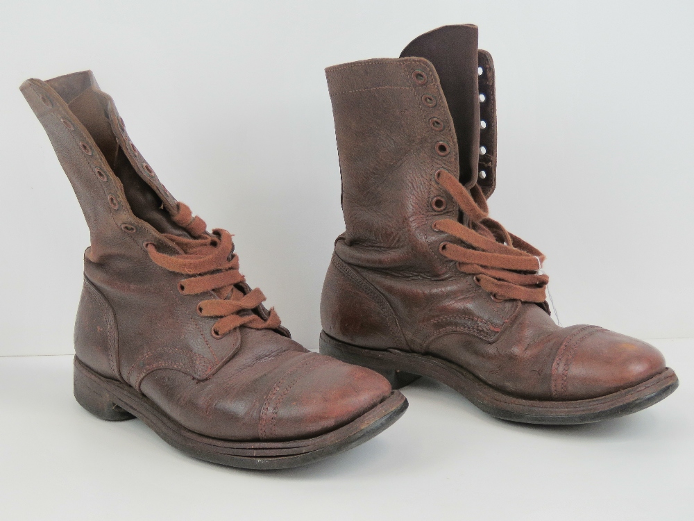 A pair of military issue boots in brown leather.