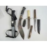 A collection of hunting daggers, including Kukri, divers knife and a selection of horn grip knives.