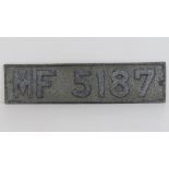 A vintage decorative car registration plate 'MF5187'.