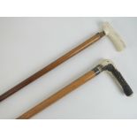 Two 19th century walking canes; one horn handled having measuring stick and spirit level within,