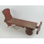 A 19th century stained wooden childs pull along wheeled truck, 62cm in length,
