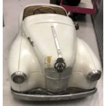 A c1950s Austin J40 pedal car in white and in original condition measuring 150cm in length,