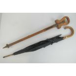 A vintage folding walnut shooting stick together with a vintage umbrella having 9ct rolled gold