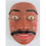 A vintage Balinese Topeng dance mask, fashioned from hardwood,