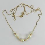 A 9ct gold fine box link chain having seven pearls and six gold beads upon, hallmarked 375,