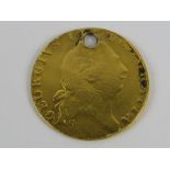 A 22ct gold George III 1803 Half-Guinea, drilled hole to top, 4g.