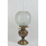 A brass oil lamp with glass chimney and shade standing 50cm high.