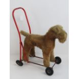 A child's push-along mohair dog on wheels by Tri-And (Lines Bros Ltd).