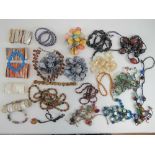 A quantity of assorted costume jewellery including; hardstone bead necklaces, glass bead necklaces,