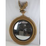 A 19th century circular bulls eye wall mirror in the Empire style having convex glass,