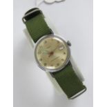 A Timex manual wind wristwatch having military style 32mm case, champagne dial with date aperture,