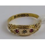 A Victorian 15ct gold gypsy style ring having central star set diamond flanked by twin rubies,