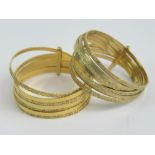 A pair of 9ct gold stacking rings, each having seven alternating bands, size T-U, 4.3g.