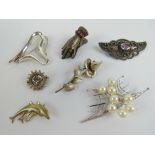 Five silver brooches being; silver and pearl cluster, dolphins, marcasite set sun, etc.