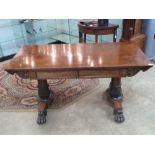 A fine Victorian rosewood centre table having twin frieze drawers and raised over substantial