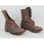 A pair of military issue boots in brown leather.