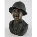 A bronze bust of a laughing child, Signed in the cast "H.